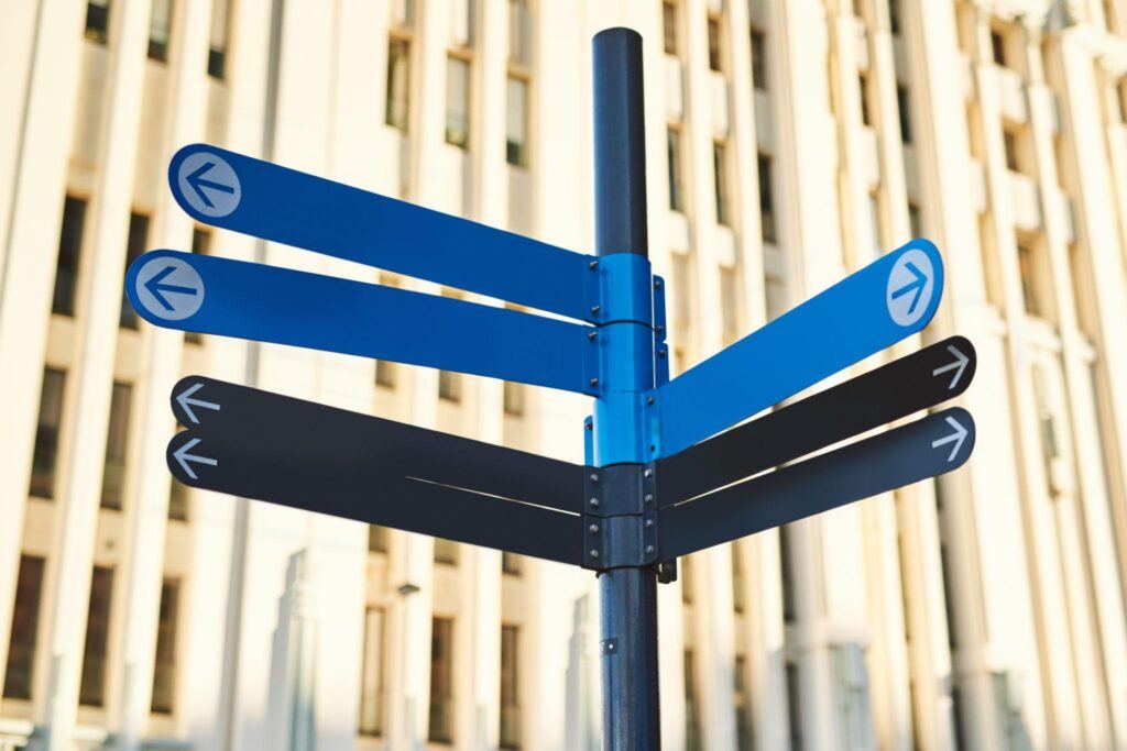 A signpost with blank direction arrows pointing several different ways